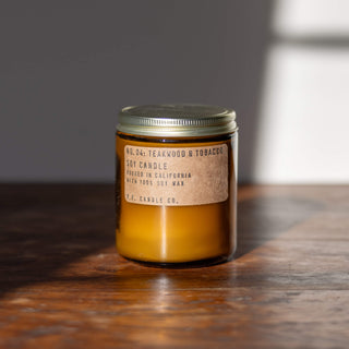 pf candle co. candle in teakwood and tobacco scent