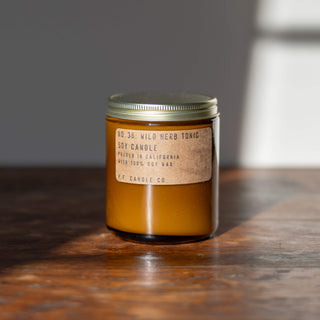 pf candle co. candle in wild herb tonic scent